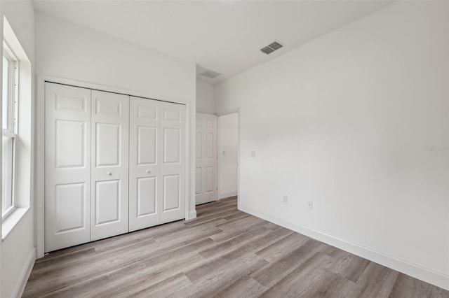 6062 SW 154th Pl, Ocala, FL 34473 - unfurnished bedroom featuring wood finished floors, a closet, and baseboards