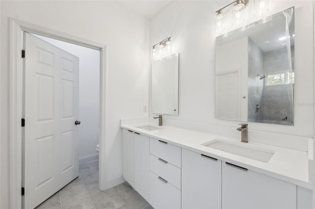 6062 SW 154th Pl, Ocala, FL 34473 - bathroom with double vanity, toilet, a tile shower, tile patterned flooring, and baseboards