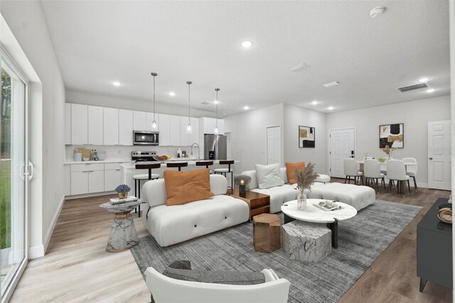 6062 SW 154th Pl, Ocala, FL 34473 - living room with recessed lighting, light wood finished floors, and baseboards