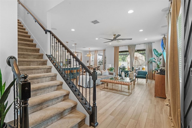 1425 Paget Cv, Sanford, FL 32771 - stairs with recessed lighting, ceiling fan, wood finished floors, and a chandelier
