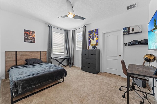 1425 Paget Cv, Sanford, FL 32771 - bedroom featuring an office area, light carpet, a textured ceiling, ceiling fan, and baseboards