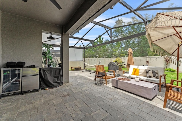 1425 Paget Cv, Sanford, FL 32771 - fenced backyard featuring a patio, ceiling fan, an outdoor living space with a fire pit, and a lanai
