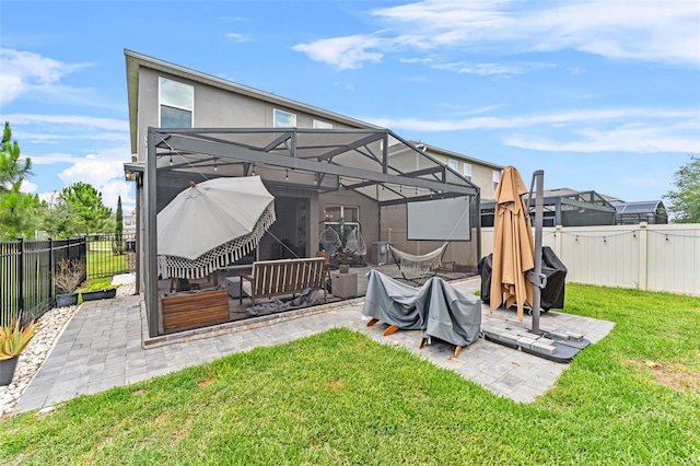 1425 Paget Cv, Sanford, FL 32771 - rear view of property with a patio, glass enclosure, and stucco siding