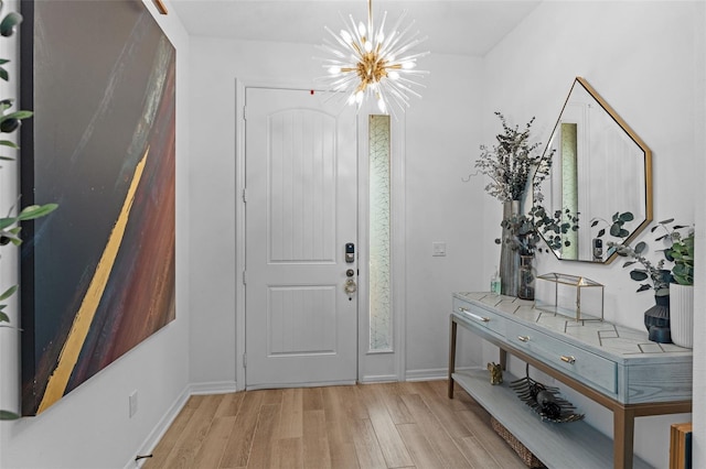 1425 Paget Cv, Sanford, FL 32771 - entrance foyer featuring a chandelier, light wood-style flooring, and baseboards