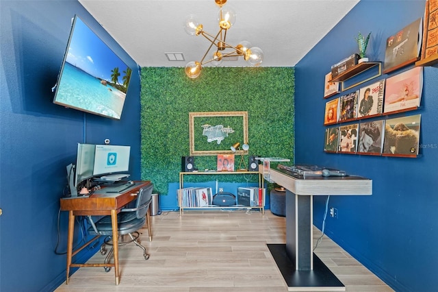 1425 Paget Cv, Sanford, FL 32771 - office area featuring a chandelier, an accent wall, wood finished floors, and baseboards