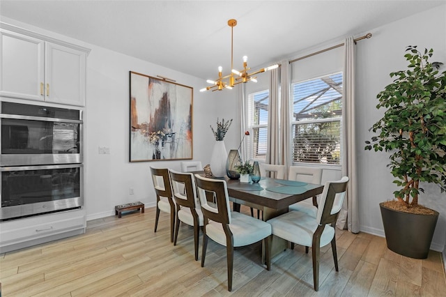 1425 Paget Cv, Sanford, FL 32771 - dining space with a chandelier, light wood-style flooring, and baseboards