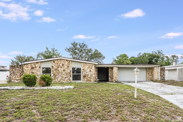 1470 Winston Rd, Maitland, FL 32751 - mid-century inspired home featuring stone siding, concrete driveway, an attached garage, and a front yard