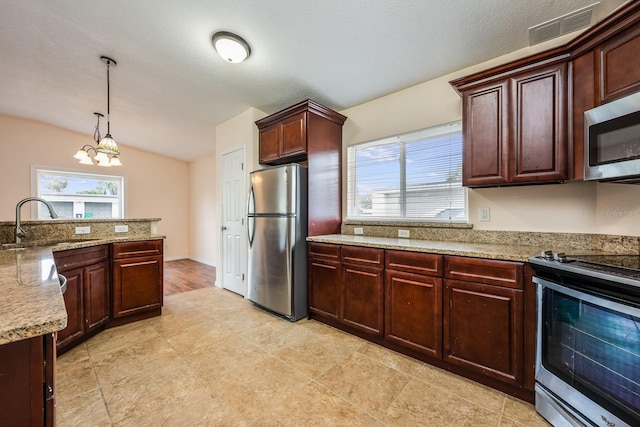 1470 Winston Rd, Maitland, FL 32751 - kitchen featuring stainless steel appliances, a sink, pendant lighting, light stone counters, and vaulted ceiling