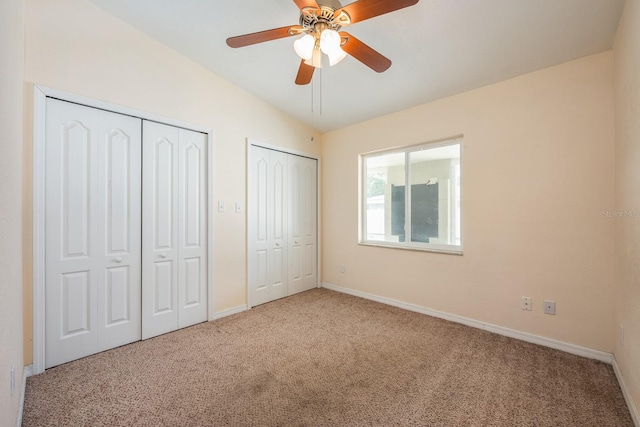 1470 Winston Rd, Maitland, FL 32751 - unfurnished bedroom with two closets, carpet flooring, baseboards, a ceiling fan, and lofted ceiling