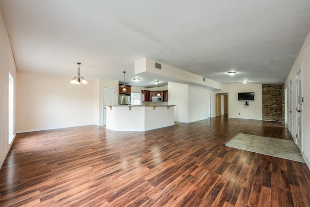 1470 Winston Rd, Maitland, FL 32751 - unfurnished living room featuring dark wood-style flooring and a chandelier