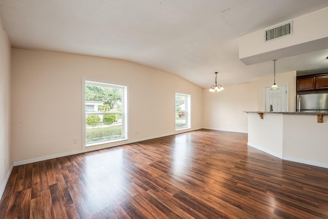 1470 Winston Rd, Maitland, FL 32751 - unfurnished living room featuring a chandelier, vaulted ceiling, dark wood-style floors, and baseboards