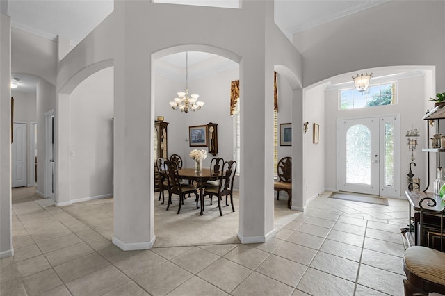 2026 Winding Oaks Dr, Orlando, FL 32825 - entrance foyer with a towering ceiling, a chandelier, baseboards, light tile patterned floors, and ornamental molding