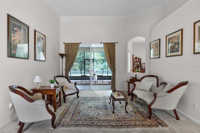 2026 Winding Oaks Dr, Orlando, FL 32825 - sitting room with arched walkways, baseboards, crown molding, and carpet
