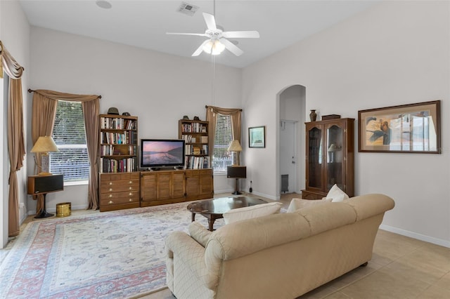 2026 Winding Oaks Dr, Orlando, FL 32825 - living area featuring arched walkways, ceiling fan, baseboards, and tile patterned floors