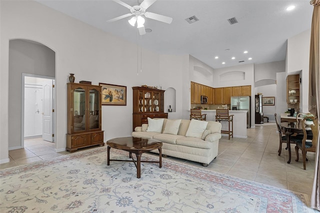 2026 Winding Oaks Dr, Orlando, FL 32825 - living area with arched walkways, a ceiling fan, light tile patterned floors, a high ceiling, and recessed lighting