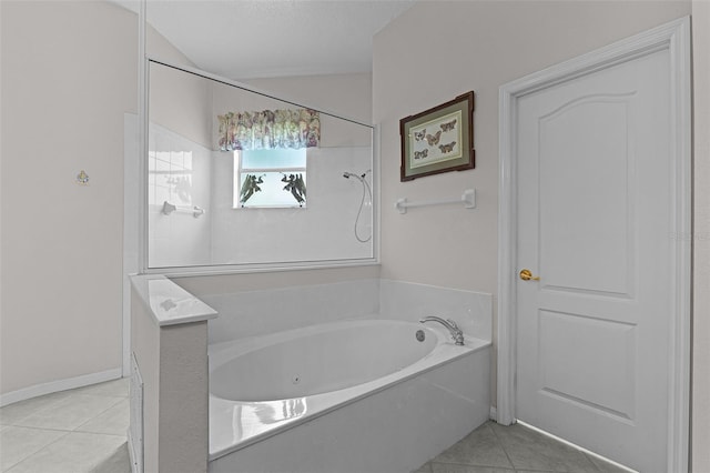 2026 Winding Oaks Dr, Orlando, FL 32825 - full bath featuring a jetted tub, tile patterned flooring, and lofted ceiling