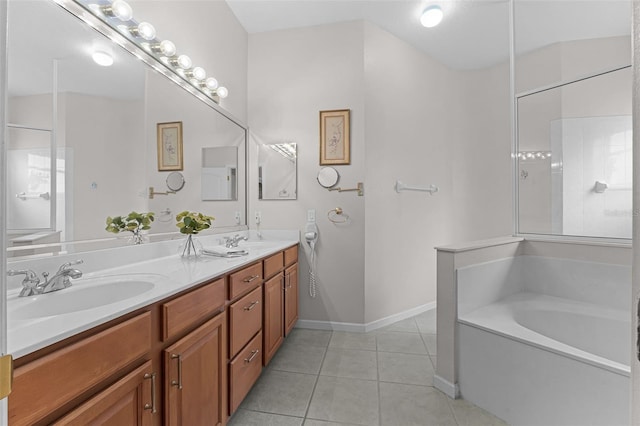 2026 Winding Oaks Dr, Orlando, FL 32825 - bathroom with tile patterned floors, double vanity, a garden tub, and baseboards