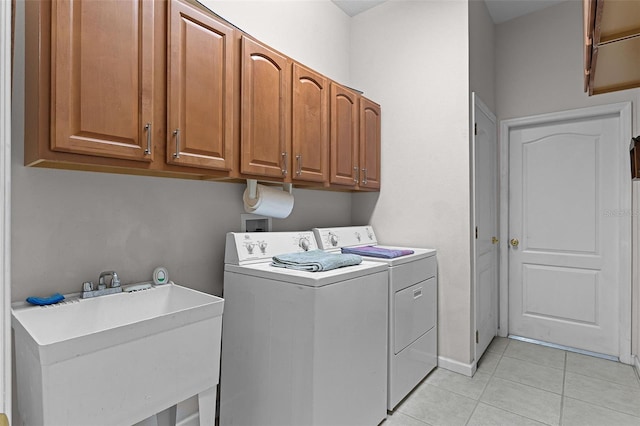 2026 Winding Oaks Dr, Orlando, FL 32825 - laundry room with separate washer and dryer, cabinet space, and light tile patterned floors