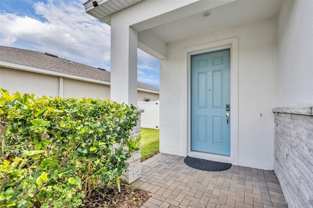 14325 Hidden Ct, Clermont, FL 34711 - property entrance featuring stucco siding and roof with shingles