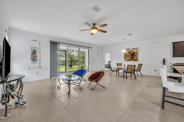 14325 Hidden Ct, Clermont, FL 34711 - living area featuring ceiling fan, light tile patterned flooring, and baseboards