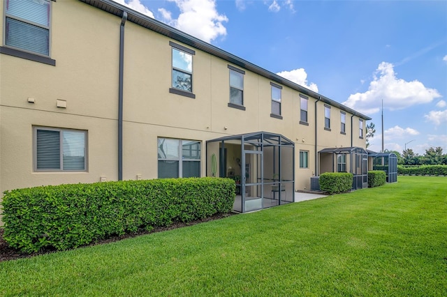 2936 Econ Landing Blvd, Orlando, FL 32825 - rear view of house with stucco siding, a yard, and cooling unit