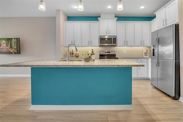 2936 Econ Landing Blvd, Orlando, FL 32825 - kitchen featuring appliances with stainless steel finishes, a sink, white cabinets, and recessed lighting