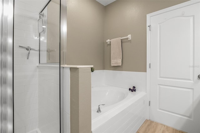 2936 Econ Landing Blvd, Orlando, FL 32825 - full bathroom with a shower stall, a bath, and wood finished floors