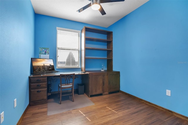 2936 Econ Landing Blvd, Orlando, FL 32825 - unfurnished office featuring a ceiling fan, wood finished floors, and baseboards