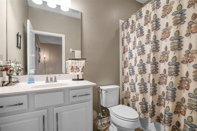 2936 Econ Landing Blvd, Orlando, FL 32825 - bathroom featuring vanity, toilet, and a textured wall