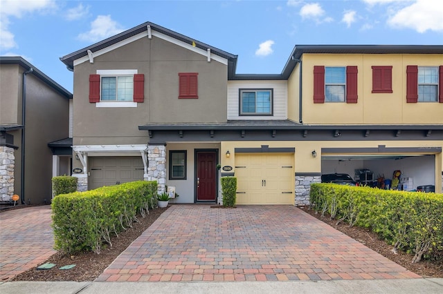 2936 Econ Landing Blvd, Orlando, FL 32825 - view of front of house featuring decorative driveway, an attached garage, stone siding, and stucco siding