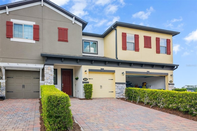 2936 Econ Landing Blvd, Orlando, FL 32825 - view of front of property with a garage, stone siding, and stucco siding