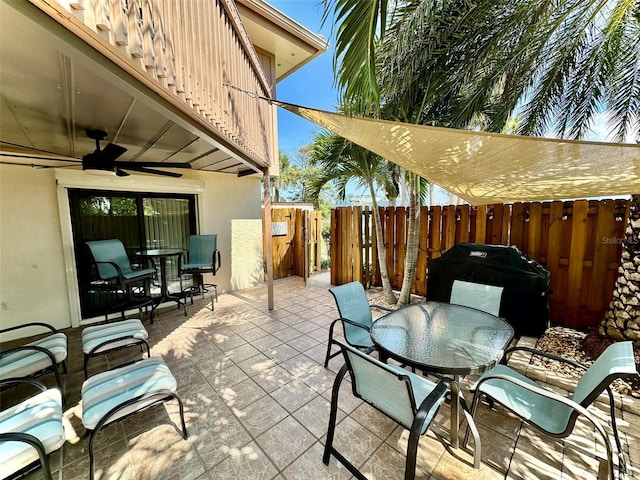 200 S Banana River Blvd Unit 703, Cocoa Beach, FL 32931 - view of patio / terrace featuring outdoor dining area, ceiling fan, and a grill