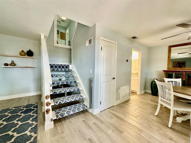 200 S Banana River Blvd Unit 703, Cocoa Beach, FL 32931 - stairs with wood finished floors, ceiling fan, and baseboards