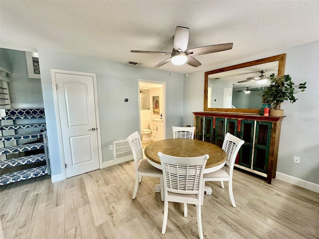 200 S Banana River Blvd Unit 703, Cocoa Beach, FL 32931 - dining space with a ceiling fan, light wood-style floors, and baseboards