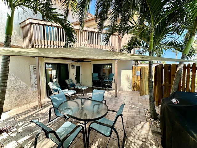 200 S Banana River Blvd Unit 703, Cocoa Beach, FL 32931 - view of patio with a balcony, outdoor dining space, ceiling fan, and grilling area