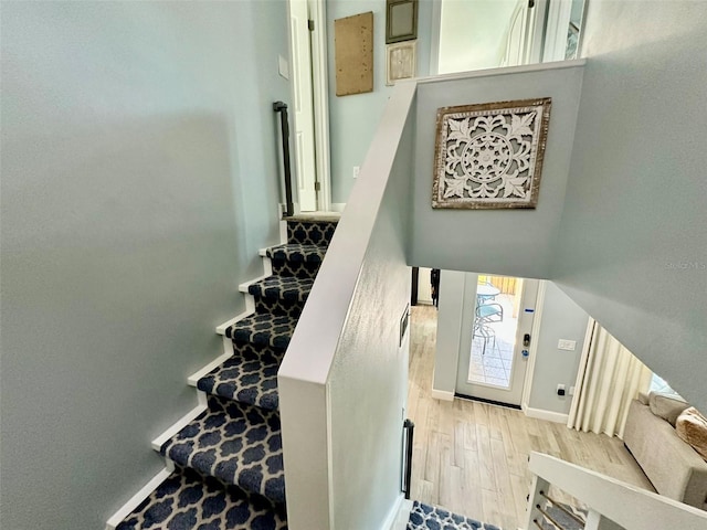 200 S Banana River Blvd Unit 703, Cocoa Beach, FL 32931 - stairs featuring wood finished floors and baseboards