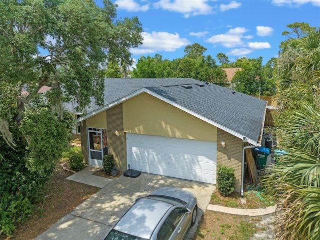 3362 Partridge St, Deltona, FL 32738 - view of property exterior with brick siding, a shingled roof, a garage, and concrete driveway
