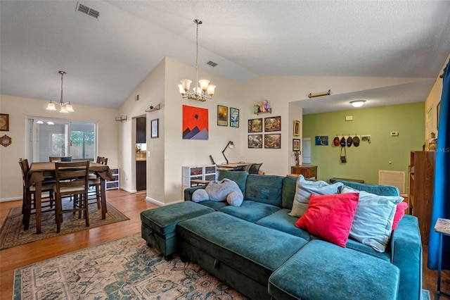 3362 Partridge St, Deltona, FL 32738 - living room featuring a chandelier, vaulted ceiling, wood finished floors, baseboards, and a textured ceiling