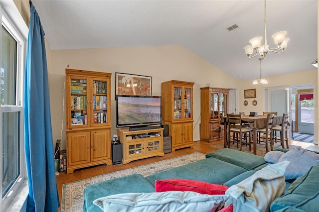 3362 Partridge St, Deltona, FL 32738 - living area featuring a chandelier, vaulted ceiling, and light wood-style floors