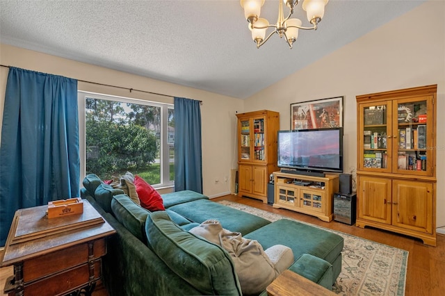 3362 Partridge St, Deltona, FL 32738 - living room with lofted ceiling, a chandelier, a textured ceiling, and wood finished floors