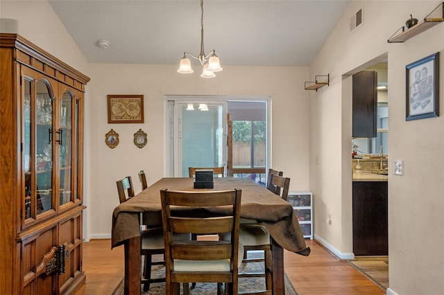 3362 Partridge St, Deltona, FL 32738 - dining space featuring light wood finished floors, a chandelier, and baseboards