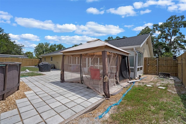 3362 Partridge St, Deltona, FL 32738 - rear view of property featuring a gazebo, a patio, a fenced backyard, and stucco siding