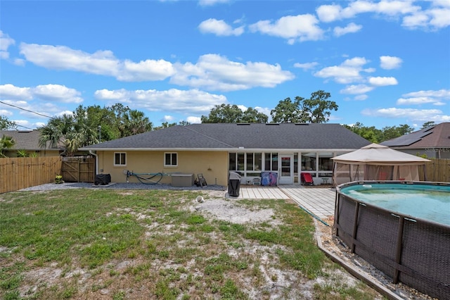 3362 Partridge St, Deltona, FL 32738 - back of property with a gazebo, a sunroom, a gate, and stucco siding