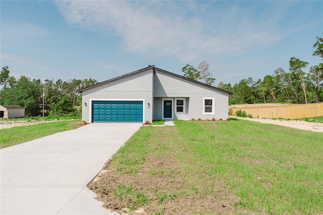 17434 SW 36th Avenue Rd, Ocala, FL 34473 - mid-century modern home featuring an attached garage, driveway, and stucco siding