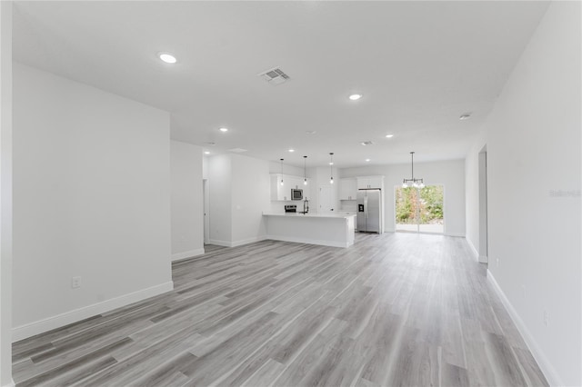 17434 SW 36th Avenue Rd, Ocala, FL 34473 - unfurnished living room featuring light wood-style flooring, recessed lighting, and baseboards