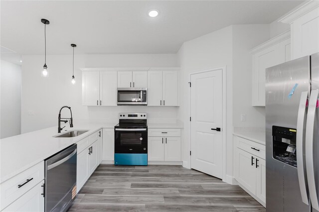 17434 SW 36th Avenue Rd, Ocala, FL 34473 - kitchen with appliances with stainless steel finishes, a sink, white cabinetry, light wood finished floors, and light countertops