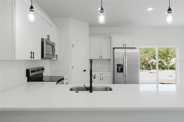 17434 SW 36th Avenue Rd, Ocala, FL 34473 - kitchen with appliances with stainless steel finishes, a sink, white cabinets, decorative light fixtures, and recessed lighting