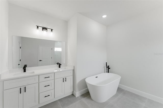 17434 SW 36th Avenue Rd, Ocala, FL 34473 - bathroom with double vanity, a freestanding bath, baseboards, tile patterned flooring, and recessed lighting