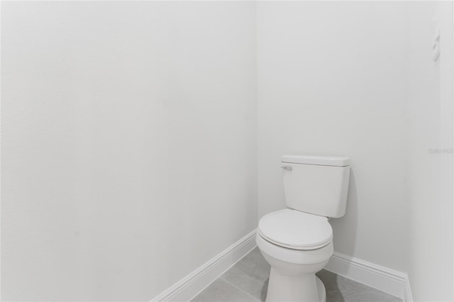 17434 SW 36th Avenue Rd, Ocala, FL 34473 - bathroom with baseboards, toilet, and tile patterned floors