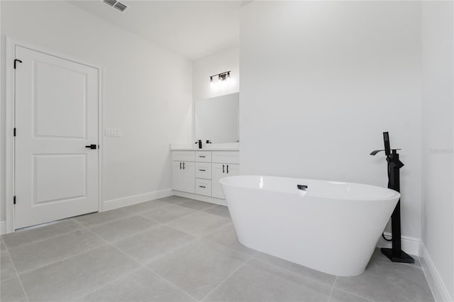 17434 SW 36th Avenue Rd, Ocala, FL 34473 - full bathroom with double vanity, a soaking tub, baseboards, and tile patterned floors